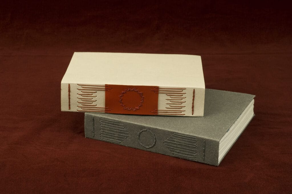 two handmade books stacked