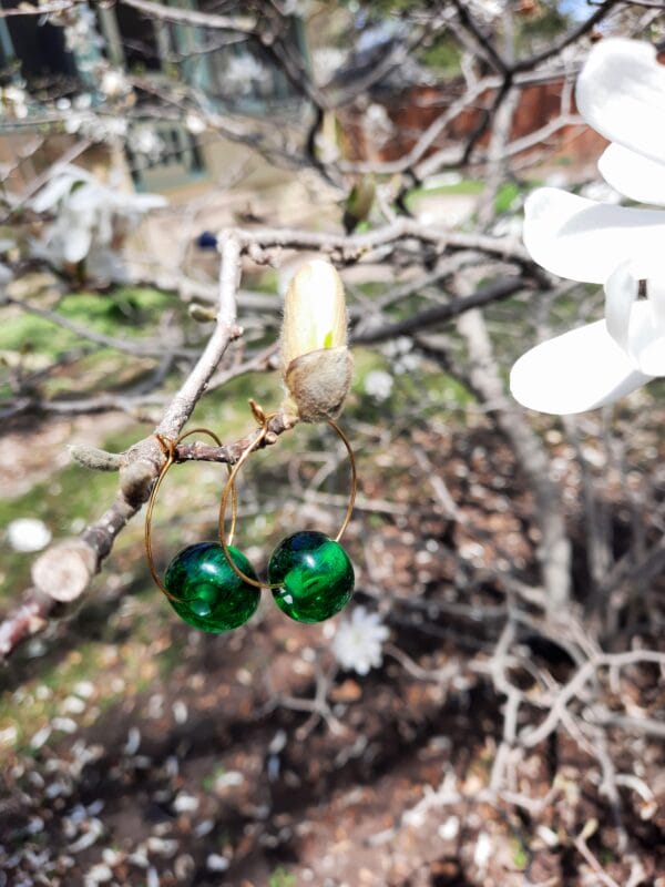 Emerald green on medium gold hoops