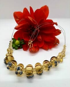 Gray flowers on amber hollows necklace