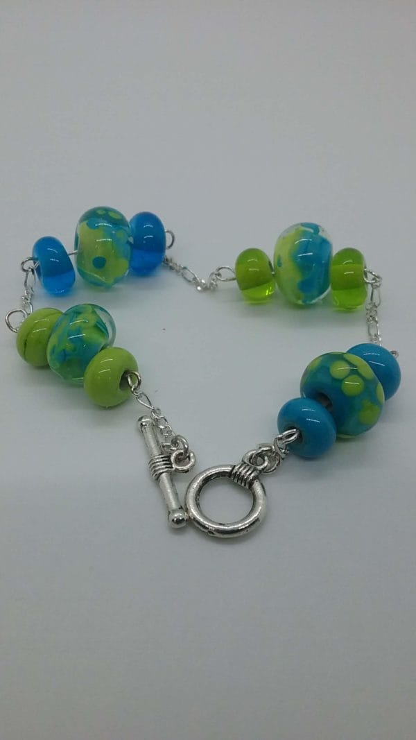 Lime and turquoise glass bead in silver chain bracelet