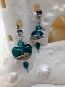 Teal and silvered ivory asymmetrical heart round dangly earrings