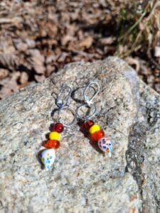 Warm white drips from silver circle on dangly earrings