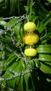 Yellow glass beads on a silver chain necklace